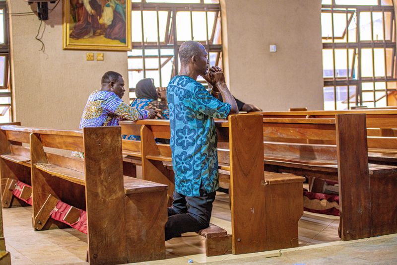 Adults praying in church - Benin City