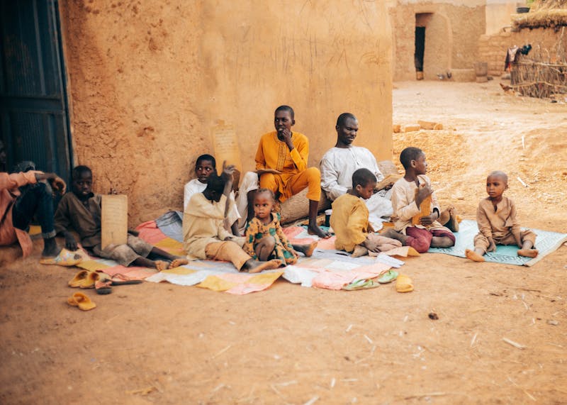 African children and elders learning outdoors